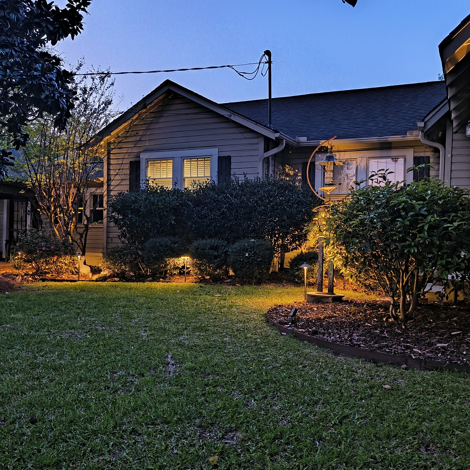 Bungalow with evening landscape lighting